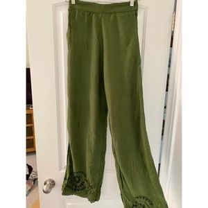 Green flare pants with crochet design at ankles